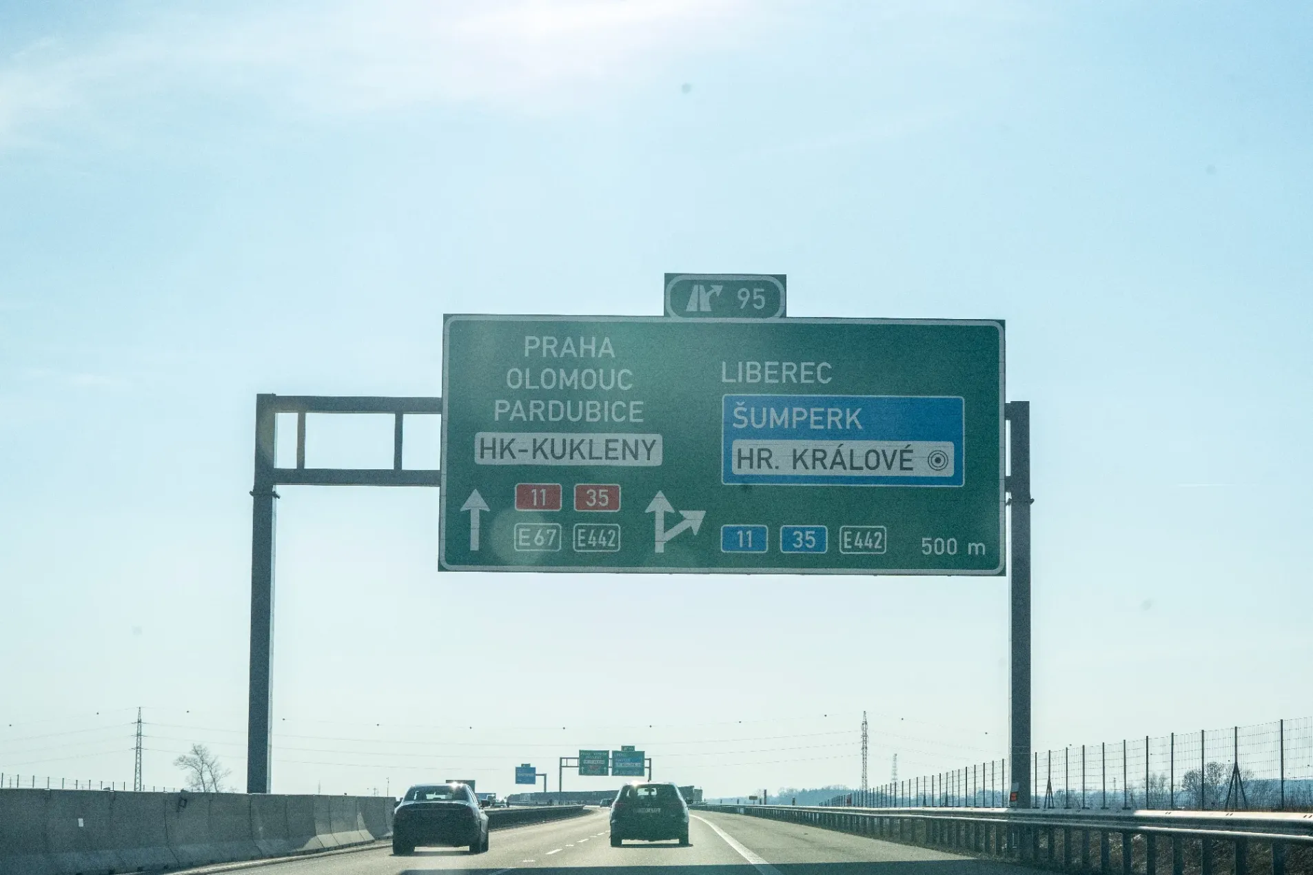 Direction sign on the D11 motorway near exit 95 at Hradec Králové showing directions to Praha, Olomouc, Pardubice and Liberec, captured on February 28, 2026